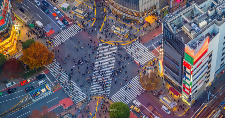 Aerial view of Shibuya Crossing in Tokyo, showcasing a bustling intersection filled with pedestrians and vehicles.