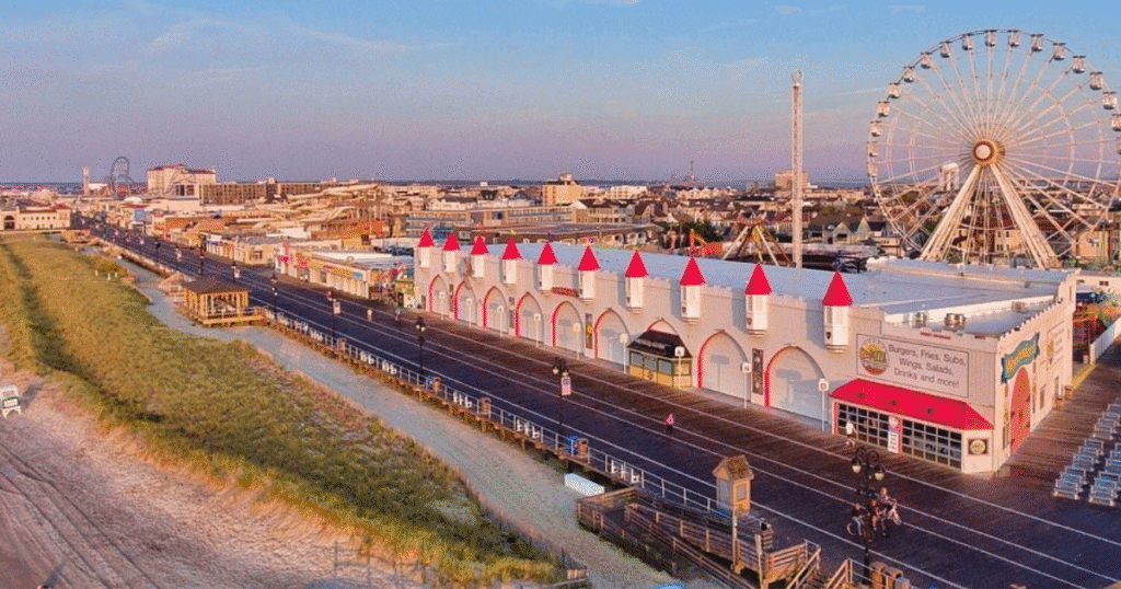 Aerial view of Gillian's Wonderland Pier in New Jersey, featuring colorful buildings and a large Ferris wheel.