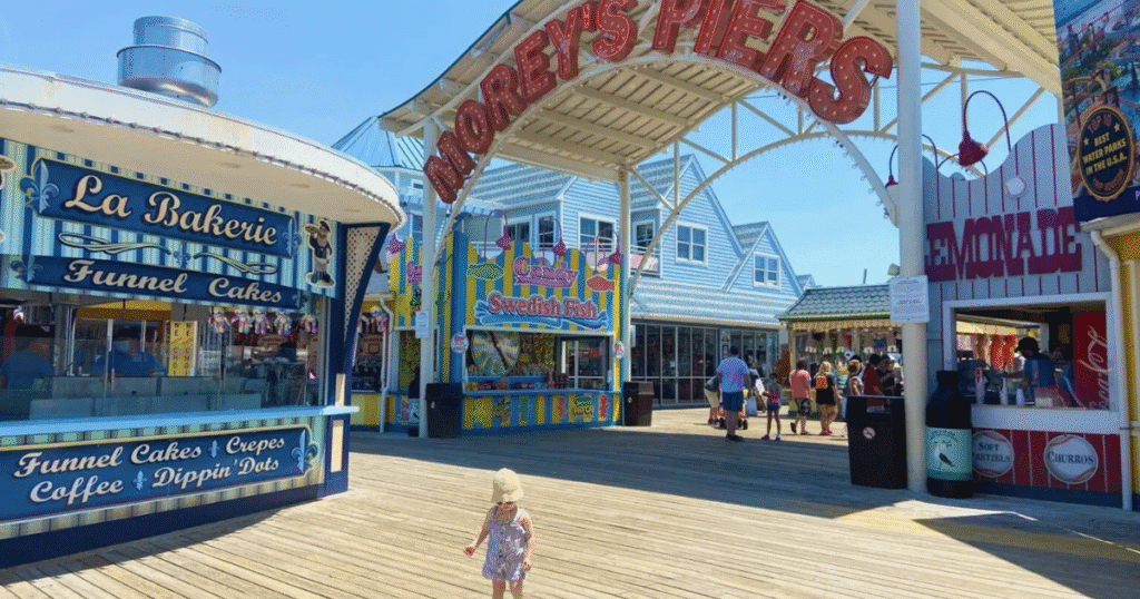 Entrance of Morey's Piers in New Jersey, featuring colorful signage and a boardwalk filled with visitors.