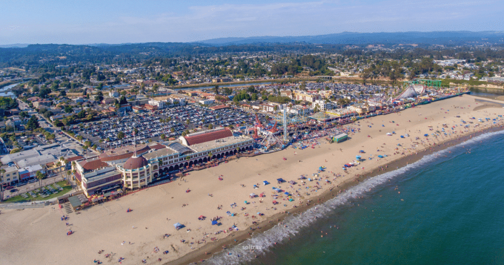 Aerial view of Santa Cruz Beach Boardwalk, California, showcasing the beach, boardwalk, and amusement rides.